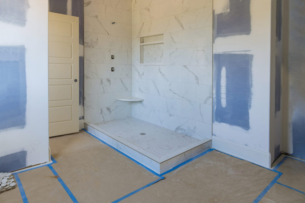 Renovation construction of master bathroom with new under construction bathroom interior drywall ready for tile in new luxury home