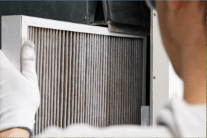 repairman fixing a furnace filter