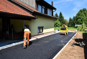 two people repaving a driveway